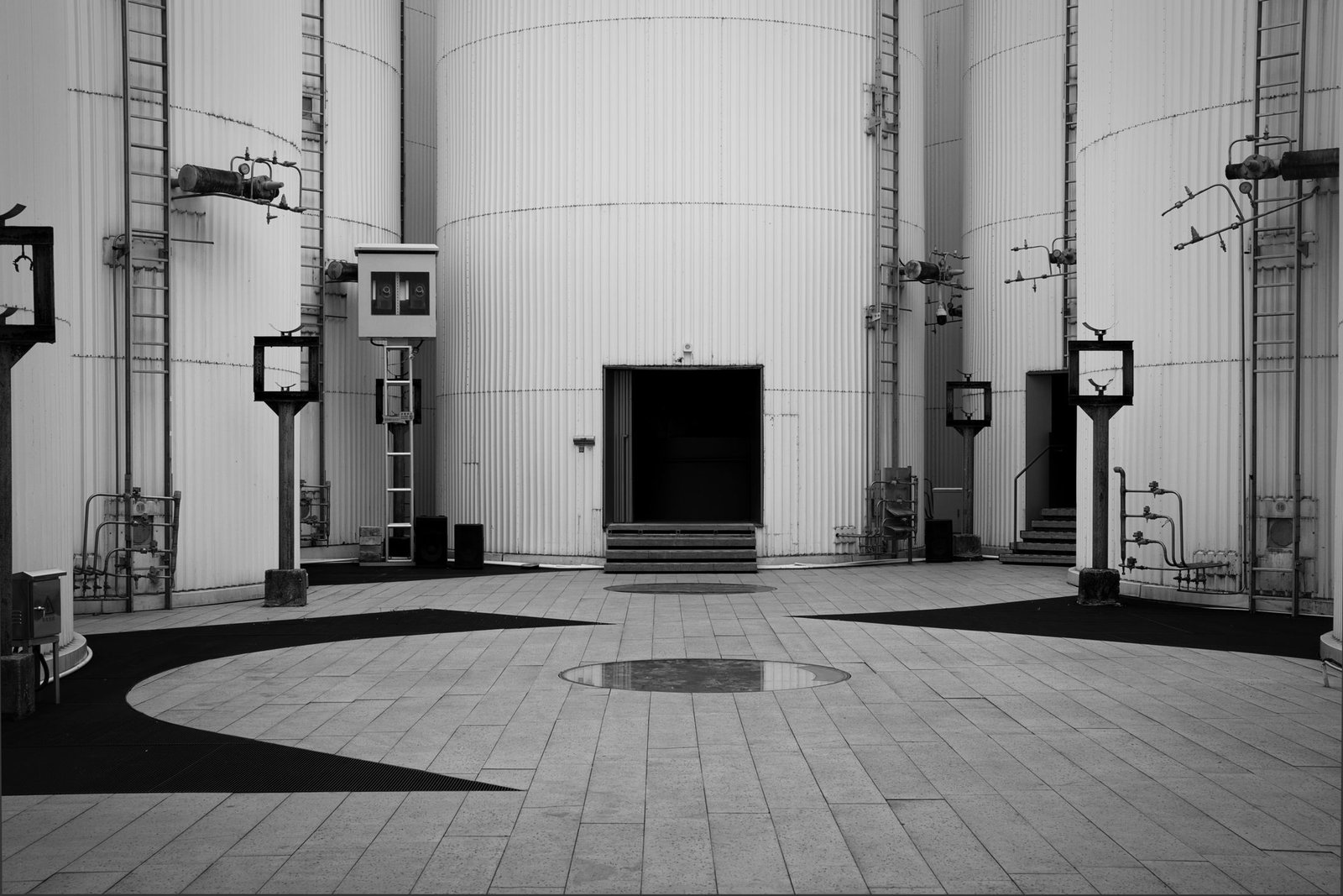 Industrial storage tanks in black and white